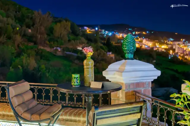 Warm lantern lighting and Moroccan wooden ceiling interior at Triana Chefchaouen
